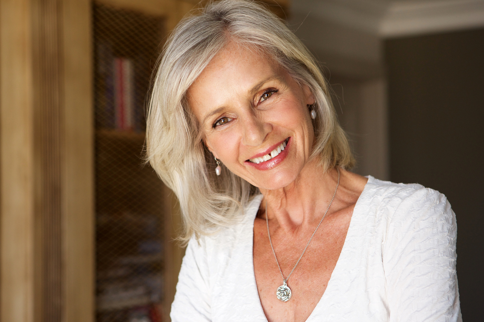 Beautiful Older Woman Standing in Study Smiling